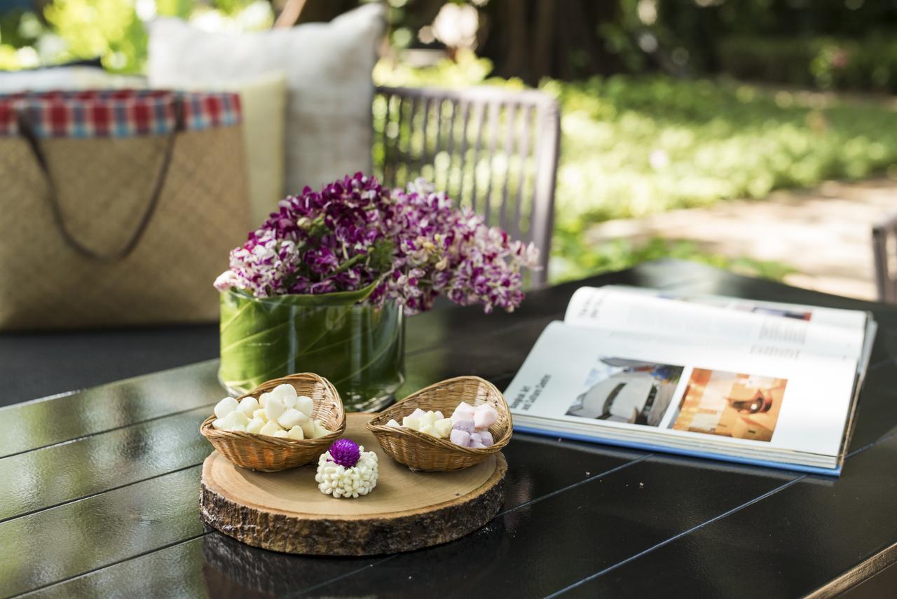 The Raweekanlaya Bangkok Extérieur photo A picnic table with a book and flowers